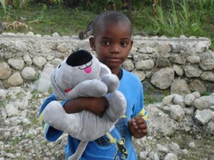 Trouble the Dog with a little boy in Haiti